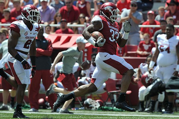 Arkansas running back Korliss Marshall runs for a touchdown during the Razorbacks' Red-White Game on Saturday, April 26, 2014 at Razorback Stadium. 