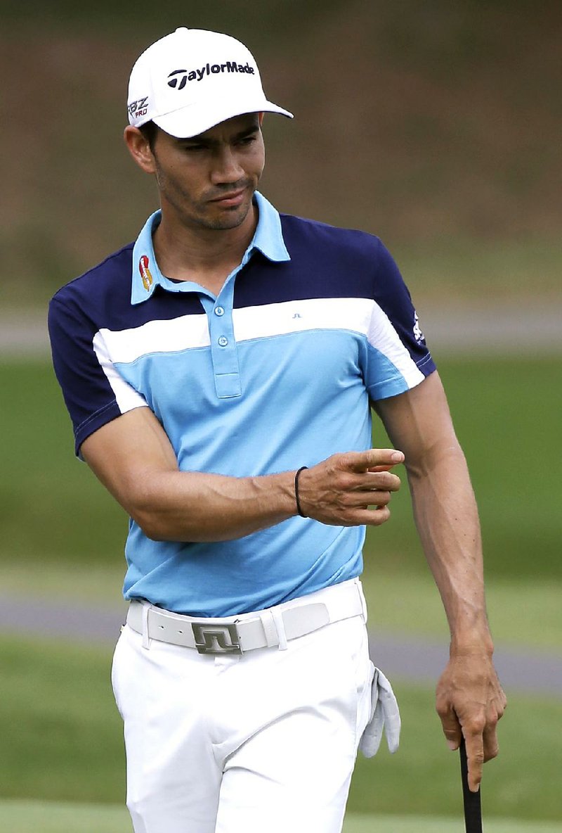 Camilo Villegas, of Colombia, reacts following a putt on the 15th green during the final round of the Wyndham Championship golf tournament in Greensboro, N.C., Sunday, Aug. 17, 2014. Villegas won the tournament with a 17 under-par 263. (AP Photo/Gerry Broome)