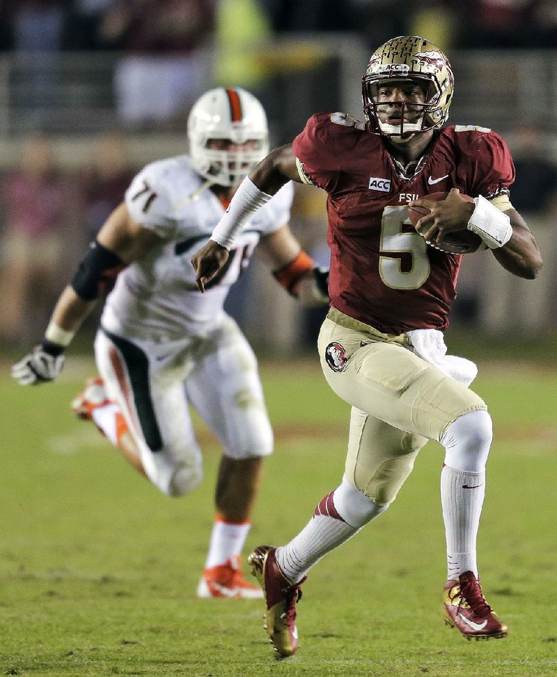 FILE - In this Nov. 2, 2013 file photo, Florida State quarterback Jameis Winston (5) outruns Miami defensive lineman Anthony Chickillo (71) during the first quarter of an NCAA college football game, in Tallahassee, Fla. Winston envisioned winning the Heisman Trophy before signing with the top-ranked Seminoles. He is one of six finalists for the award and will find out Saturday if his dream comes true.(AP Photo/Chris O'Meara, File)