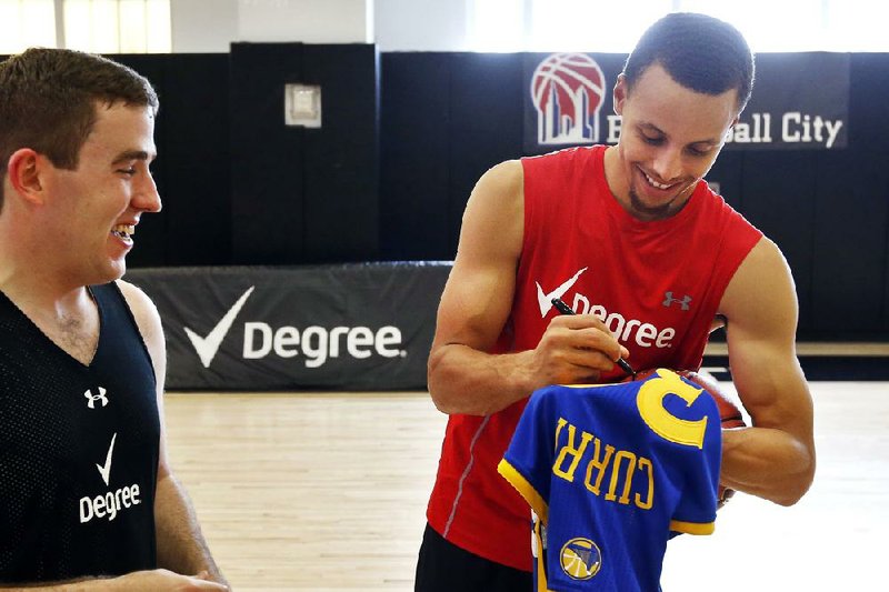 IMAGE DISTRIBUTED FOR DEGREE - Golden State Warriors point guard Stephen Curry leads the Degree Men DOMORE Three "Point" Basketball Clinic at Basketball City, Tuesday, Aug. 12, 2014 in New York. (Jason DeCrow/AP Images for Degree)