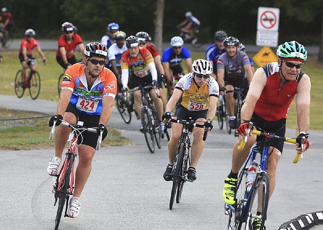 Arkansas Democrat-Gazette/RICK MCFARLAND --09/28/13--  Cyclists riding in the Big Dam Bridge 100 navaigate some curves on the route through Cooks Landing in North Little Rock Saturday. Riders could register to ride 15 to 100 miles in the event.