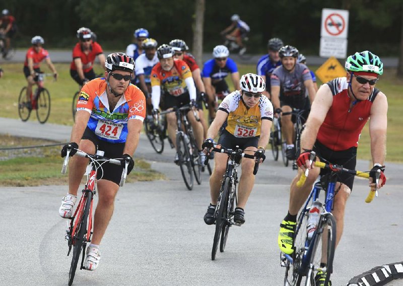 Arkansas Democrat-Gazette/RICK MCFARLAND --09/28/13--  Cyclists riding in the Big Dam Bridge 100 navaigate some curves on the route through Cooks Landing in North Little Rock Saturday. Riders could register to ride 15 to 100 miles in the event.