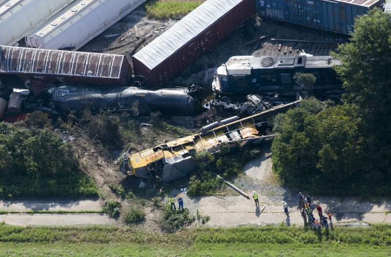 Arkansas Democrat-Gazette/MELISSA SUE GERRITS - 08/17/2014 - Workers respond to the aftermath of a 3am head on collision of 2 Union Pacific trains outside of Hoxie in Lawrence County August 17, 2014. 2 individuals were killed and 2 reported injured all believed to be among the crews onboard the freight trains. Due to toxic chemical cargo, some members of Hoxie were evacuated and directed to the Walnut Ridge community center. All highways leading into Hoxie were blocked by Arkansas State Police and local law enforcement personnel, directing individuals to Hwy. 91 East of Hoxie. 
