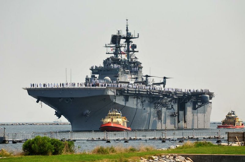 The USS Iwo Jima sails into Mayport Naval Station, its new home port in Jacksonville, Fla. on Sunday, Aug. 17, 2014. The USS Fort McHenry also arrived at Mayport on Sunday. (AP Photo/The Florida Times-Union, Will Dickey)