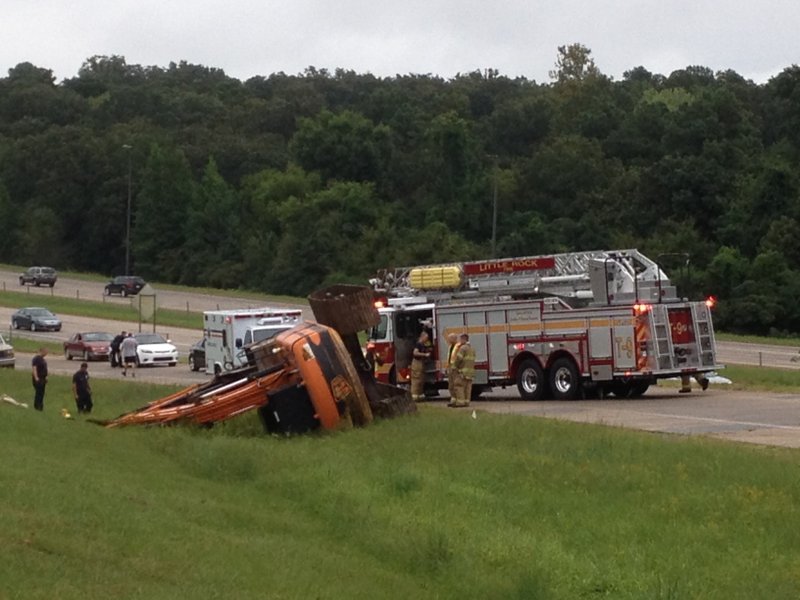 A flipped excavator blocks to traffic the Interstate 430 South ramp to Rodney Parham Road in Little Rock on Monday, Aug. 18, 2014.