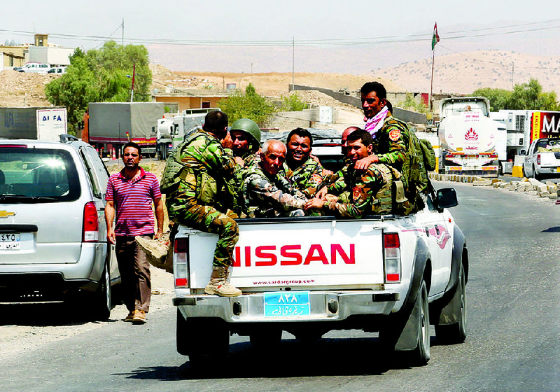 Kurdish forces, known as the Peshmerga, make their way to the front line to fight militants from the extremist Islamic State group at Mosul Dam, outside Mosul, Iraq, Monday, Aug 18, 2014. Boosted by two days of U.S. airstrikes, Iraqi and Kurdish forces on Monday wrested back control of the country's largest dam from Islamic militants, a military spokesman in Baghdad said, as fighting was reported to be underway for the rest of the strategic facility. (AP Photo/Khalid Mohammed)