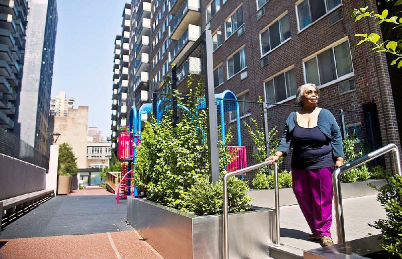 In this Aug. 5, 2014 photo, Jean Green Dorsey walks outside the building on New York City’s Upper West Side where she has lived since 1972. Dorsey has a rent stabilized unit in a building that also houses market rate residents. As a rent stabilized tenant, Dorsey is not allowed to use the new gym that market rate residents use for free, even if she paid for the privilege. (AP Photo/Bebeto Matthews)