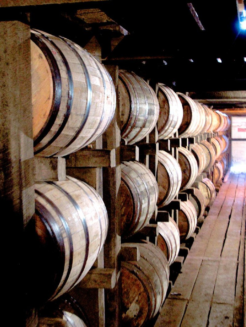 In a July 24, 2014 photo, bourbon supplies age in barrels at the Jim Beam distillery in Clermont, Ky. Kentucky bourbon makers have stashed away their largest stockpiles in more than a generation due to resurgent demand for the venerable brown spirit. (AP Photo/Bruce Schreiner)