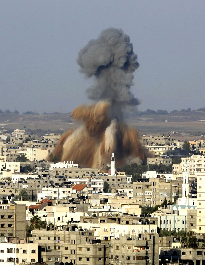 Smoke and debris rise after an Israeli strike hit Gaza City in the northern Gaza Strip on Tuesday.