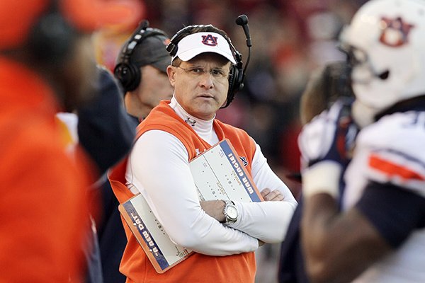 Auburn coach Gus Malzahn, center, watches the first half of an NCAA college football game against Arkansas in Fayetteville, Ark., Saturday, Nov. 2, 2013. (AP Photo/Danny Johnston)