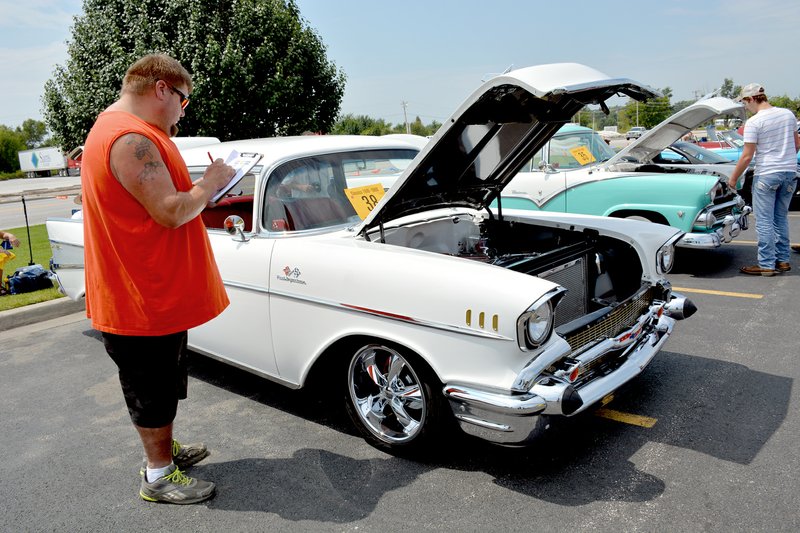 Tina Parker/Herald-Leader First-year judge George Rickey of Farmington, rates a 1950s Crown Victoria. The categories that he judged were Classic 1900-1960; Custom 1900-1960; and Custom 1961-1980.