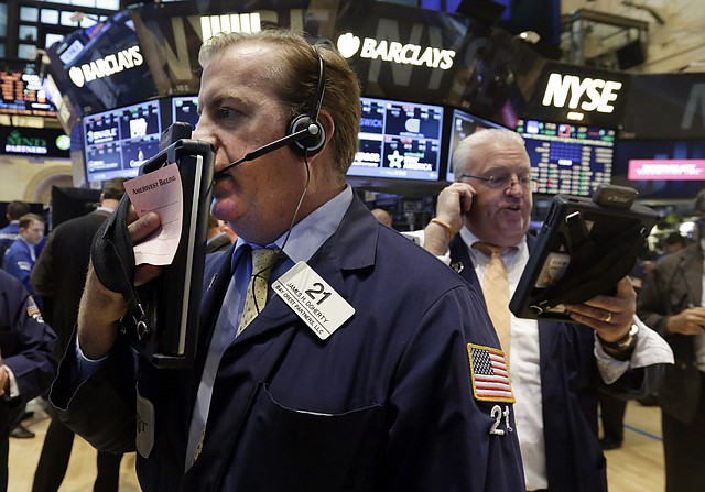 Traders James Doherty, left, and Thomas Ferrigno work on the floor of the New York Stock Exchange Tuesday, Aug. 19, 2014. Better news on home building and corporate earnings are sending stocks higher.