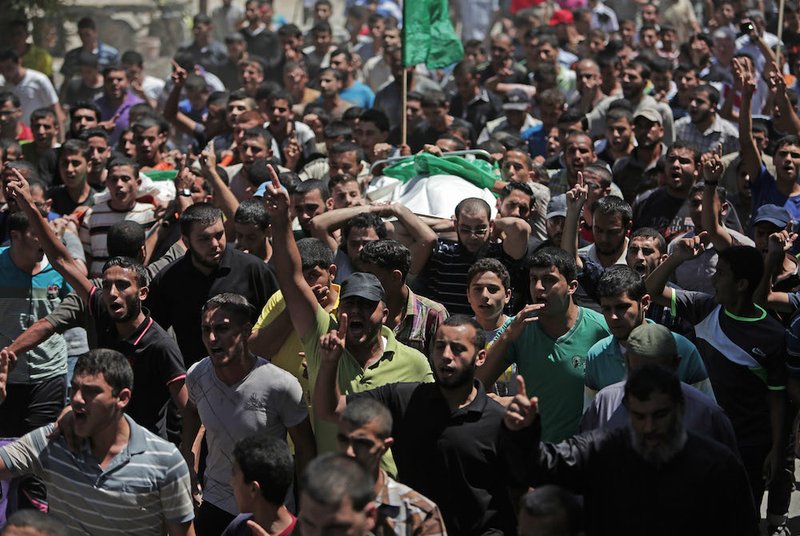 Mourners chant angry slogans during the funeral of Widad Mustafa Deif, 27, who was killed along with her 8-month-old son Ali Mohammed Deif in Israeli strikes in Gaza City late Tuesday, during their funeral in Jabaliya refugee camp in the northern Gaza Strip on Wednesday, Aug. 20, 2014. Widad was the wife of Mohammed Deif, the leader of the Hamas military wing.