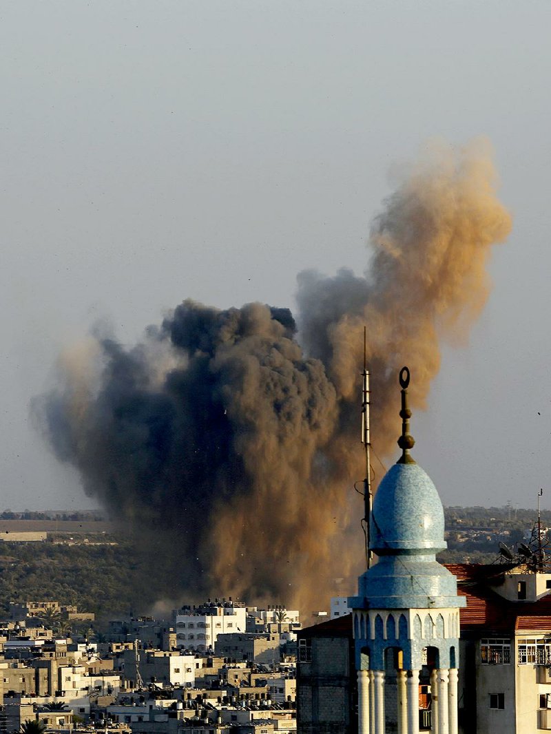 Smoke, dust and debris rise Wednesday after an Israeli strike hit Gaza City in the northern Gaza Strip.