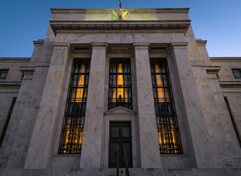 This Sept. 18, 2013 file photo shows the Federal Reserve headquarters in Washington. Minutes of the Fed's discussion at its July 29-30, 2014 meeting show that some officials thought the economy was improving enough that the Fed would need "to call for a relatively prompt move" toward reducing the support it has been providing. Otherwise, they felt the Fed risked overshooting its targets for unemployment and inflation. 