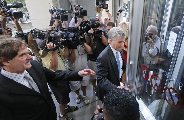 Former Virginia Gov. Bob McDonnell, right, arrives at federal court with his attorney, Henry Asbill, left, Wednesday, Aug. 20, 2014, in Richmond, Va.  The defense continues to present it's case in the McDonnell's corruption case. 