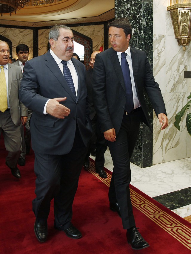 Iraq's Foreign Minister Hoshiyar Zebari, left, walks with Italy's Prime Minister Matteo Renzi in Baghdad, Iraq, Wednesday, Aug. 20, 2014. Renzi started a one-day visit to Iraq, meeting with the outgoing Prime Minister, Nouri al-Maliki, and premier-designate, Haider al-Abadi, along with other officials.