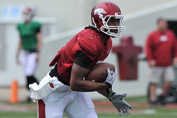 Arkansas receiver Damon Mitchell returns a punt during practice on Saturday, April 12, 2014 at Razorback Stadium in Fayetteville. 