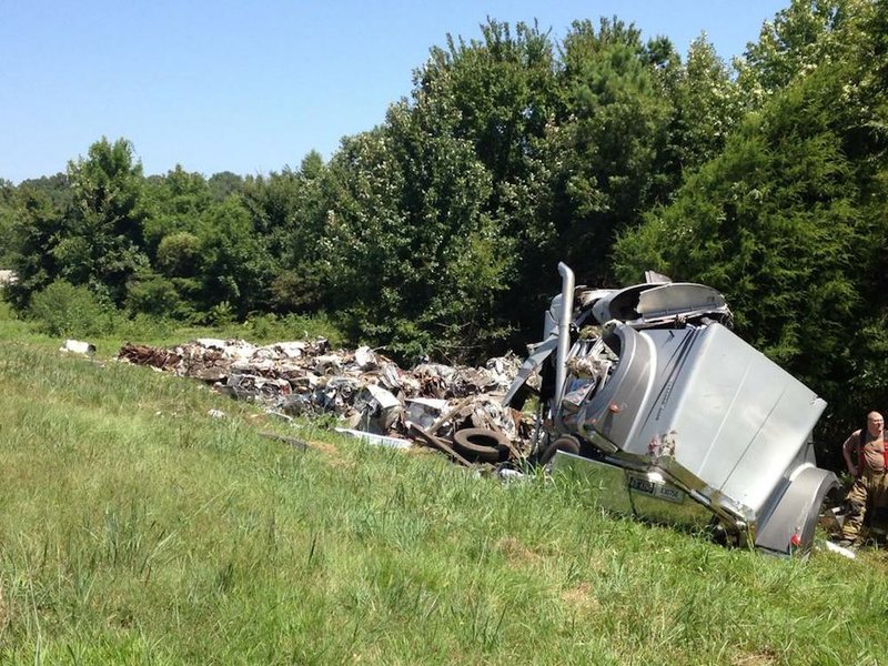 An 18-wheeler crashes and spills its load off an eastbound Interstate 40 exit ramp Thursday, Aug. 21, 2014.