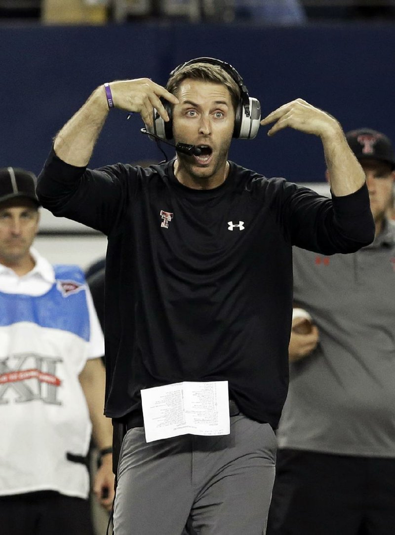 FILE - In this Nov. 16, 2013 file photo, Texas Tech head coach Kliff Kingsbury yells form the sideline during the first half of an NCAA college football game against Baylor in Arlington, Texas.  Strong told Longhorns fans Texas "will not be in the national championship game."  (AP Photo/LM Otero, File)