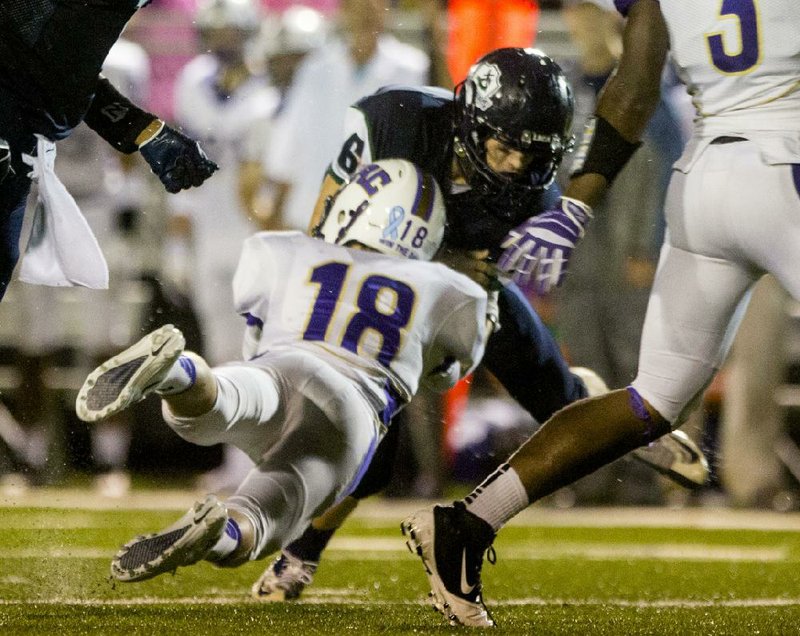 Arkansas Democrat-Gazette/MELISSA SUE GERRITS 09/20/13 -Central Arkansas Christian's Zac Lilly tackles Little Rock Christian Academy's Hunter McFarlane during their game against  September 20, 2013. 