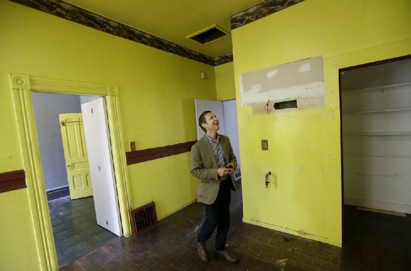 FILE - In this July 30, 2014 file photo, George Limperis, a realtor with Paragon Real Estate Group, walks through the kitchen of a property in the Noe Valley neighborhood in San Francisco. On Thursday, Aug. 21, 2014, the National Association of Realtors is scheduled to report on existing-home sales in July 2014. (AP Photo/Jeff Chiu, File)