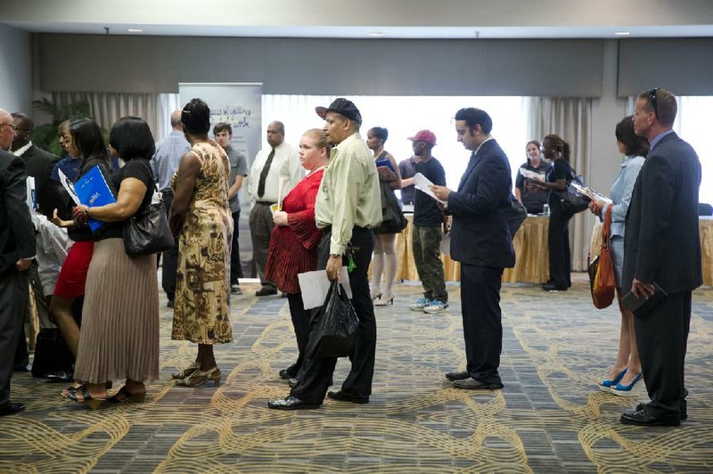 In this June 23, 2014 photo, people wait in line to meet with recruiters during a job fair in Philadelphia. The Labor Department reports on the number of people who applied for unemployment benefits last week on Thursday, Aug. 21, 2014. (AP Photo/Matt Rourke)