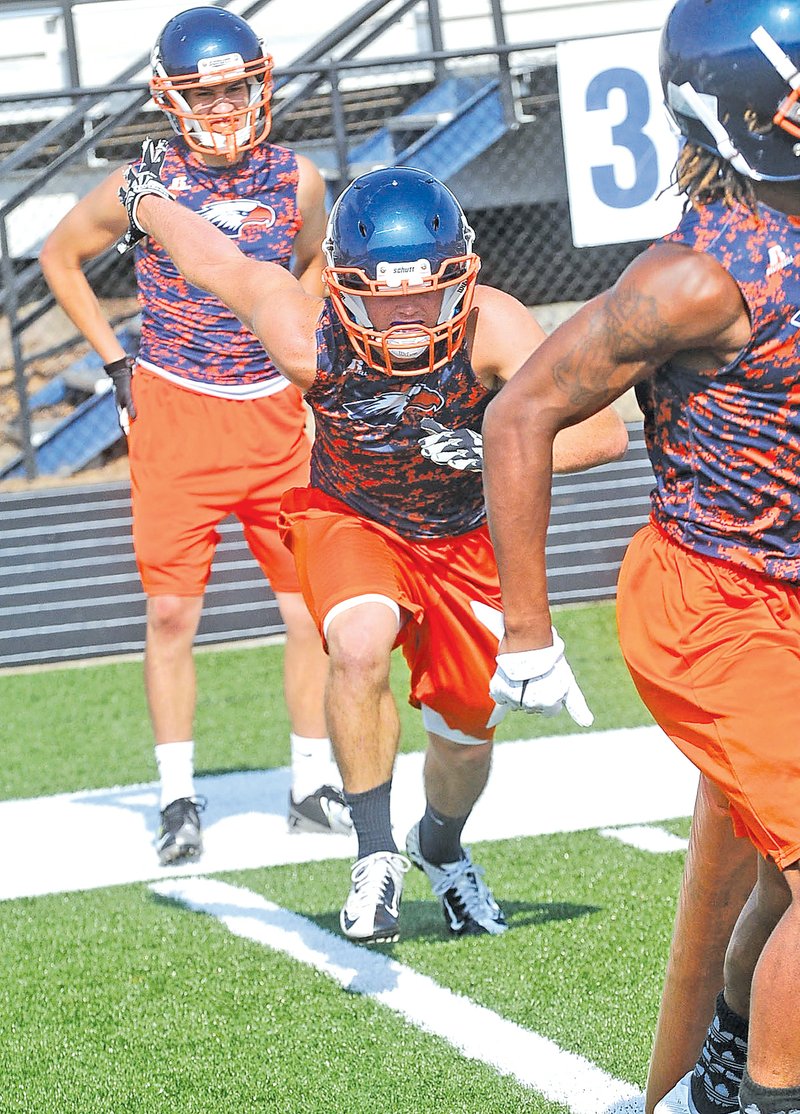  STAFF PHOTO FLIP PUTTHOFF Garrett Sheetz of Rogers Heritage goes through a tackling drill during practice on Aug. 5.