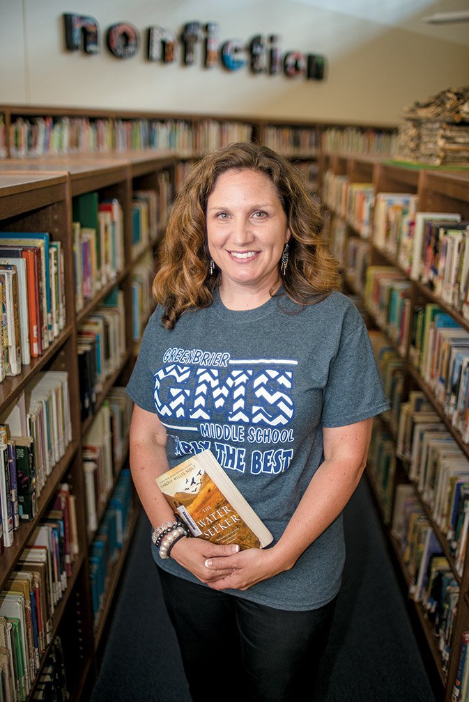 Erin Shaw, Greenbrier Middle School’s library media specialist, holds a copy of The Water Seeker, by Kimberly Willis Holt of Texas. Shaw met the author on a plane, and they became friends. Holt came to Greenbrier to talk with students, and Shaw had students and faculty read The Water Seeker. “It’s one of those, whether you’re in sixth grade or your 60s — people love it,” Shaw said.