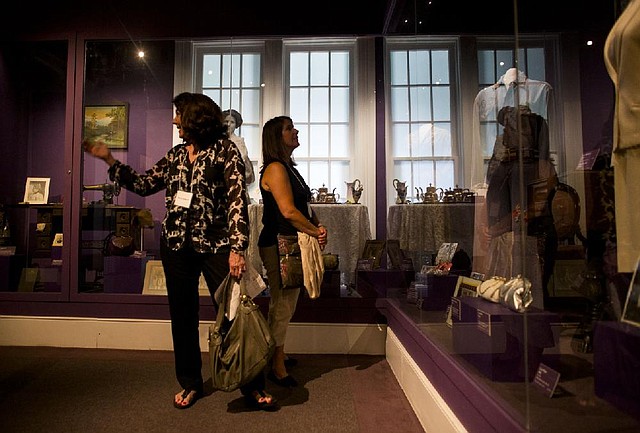 Arkansas Democrat-Gazette/MELISSA SUE GERRITS - 08/22/2014 - Brenda Parker, left, and Claudia Moran look at dresses on display at the Old State House Museum in the First Ladies of Arkansas inaugural gown collection August 22, 2014. The collection includes inaugural gowns representing 120 years of Arkansas History. Several of the gowns have show rapid deterioration and are in need of immediate conservation. The display will be closed for some time beginning September 8. 