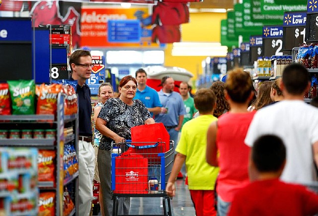 Shoppers crowd the aisles following the Aug. 13 grand opening of a Wal-Mart Supercenter in Springdale.