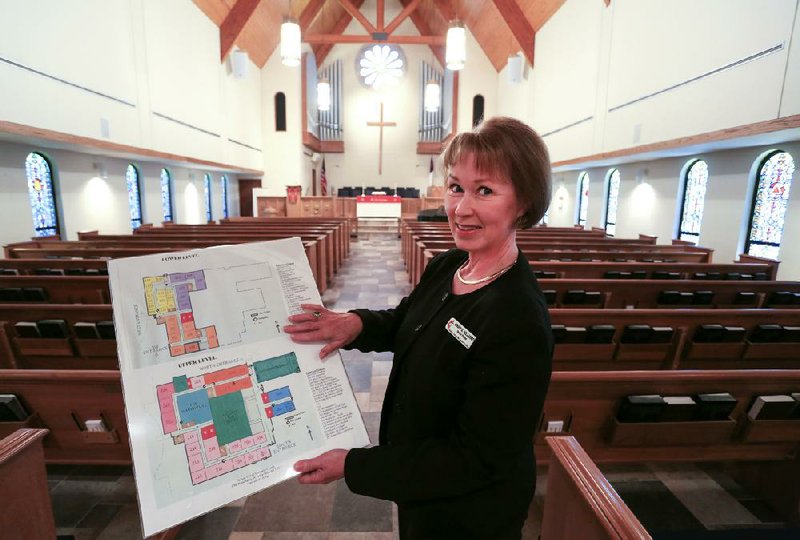 Arkansas Democrat-Gazette/RICK MCFARLAND--08/20/14--   Rev. Mary Hilliard with one of their fire evacuation routes that they have placed in various locations at Asbury United Methodist Church, 1700 Napa Valley Drive, in Little Rock. The congregation recently held fire drills with help from the Little Rock Fire Department to develope the routes.