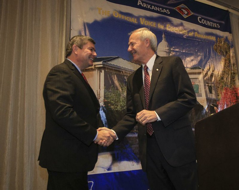  Arkansas Democrat-Gazette/STATON BREIDENTHAL --8/22/14-- Democratic gubernatorial candidate Mike Ross, left, and Republican  candidate Asa Hutchinson shake hands before answering questions Friday morning in Little Rock during a candidate forum at a meeting of the Arkansas Association of Counties.