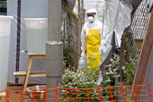 A healthcare worker walks near a Ebola isolation unit wearing protective gear against the virus at Kenema Government Hospital, in Kenema that is in the Eastern Province around 300km, (186 miles), from the capital city of Freetown in Kenema, Sierra Leone, Tuesday, Aug. 12, 2014. The World Health Organization declared Tuesday, it is ethical for unproven drugs and vaccines to be used amid an unprecedented outbreak in West Africa, however it didn’t address who should get the limited amount of drugs available and can not predict the result of using untested drugs.