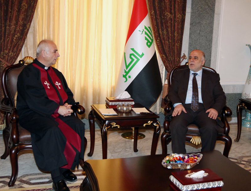 Iraqi premier- designate Haider al-Abadi, right, meets with Pastor Farouk Youssuf in Baghdad, Iraq, Thursday, Aug. 21, 2014. Al-Abadi has until Sept. 11 to submit a list of Cabinet members to parliament for approval. Religious and ethnic minorities have called upon him to assemble an all-inclusive government.