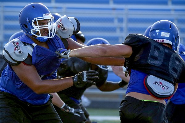 Conway High School's offensive lineman Colton Jackson works the line during practice Monday, Aug. 23, 2014, in Conway.