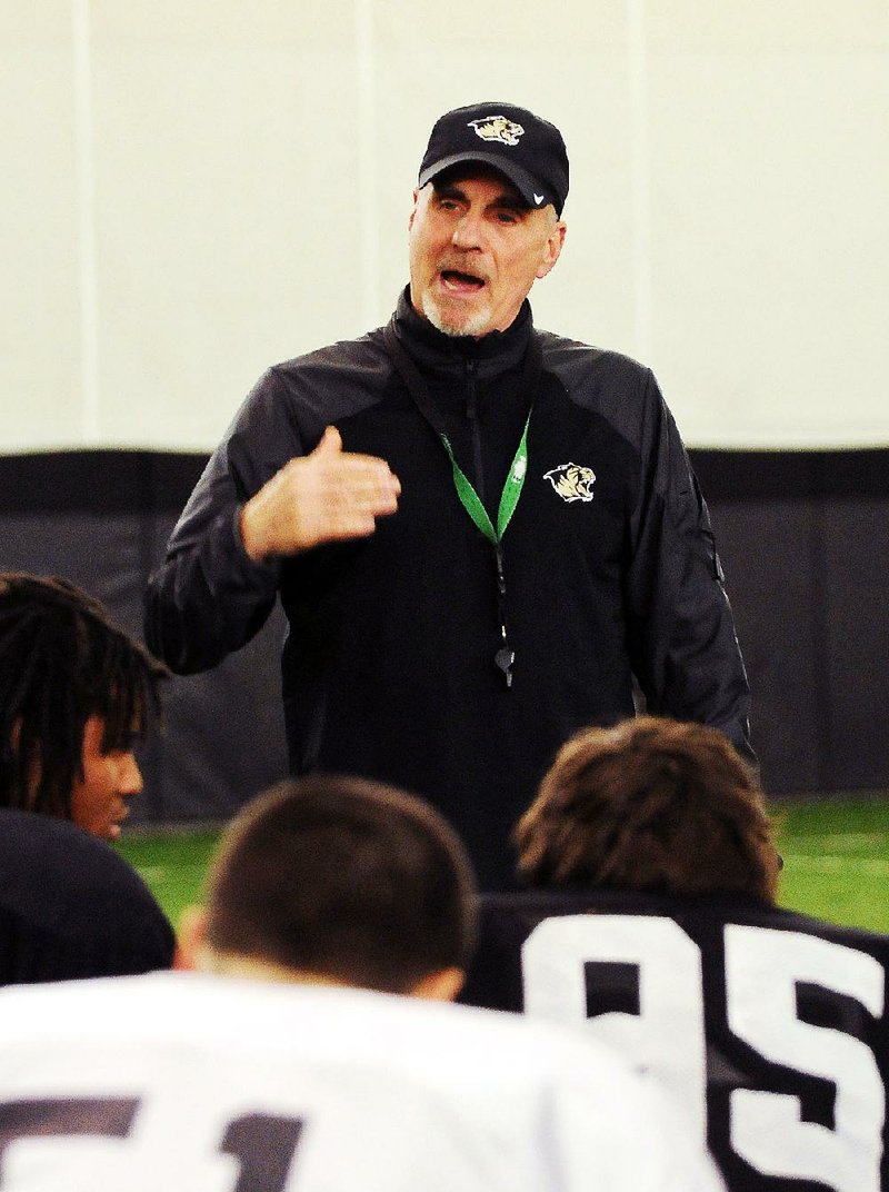 Coach Barry Lunney addresses the Bentonville High football team during practice in the school's Tiger Athletic Complex in Bentonville on Monday December 9, 2013. 