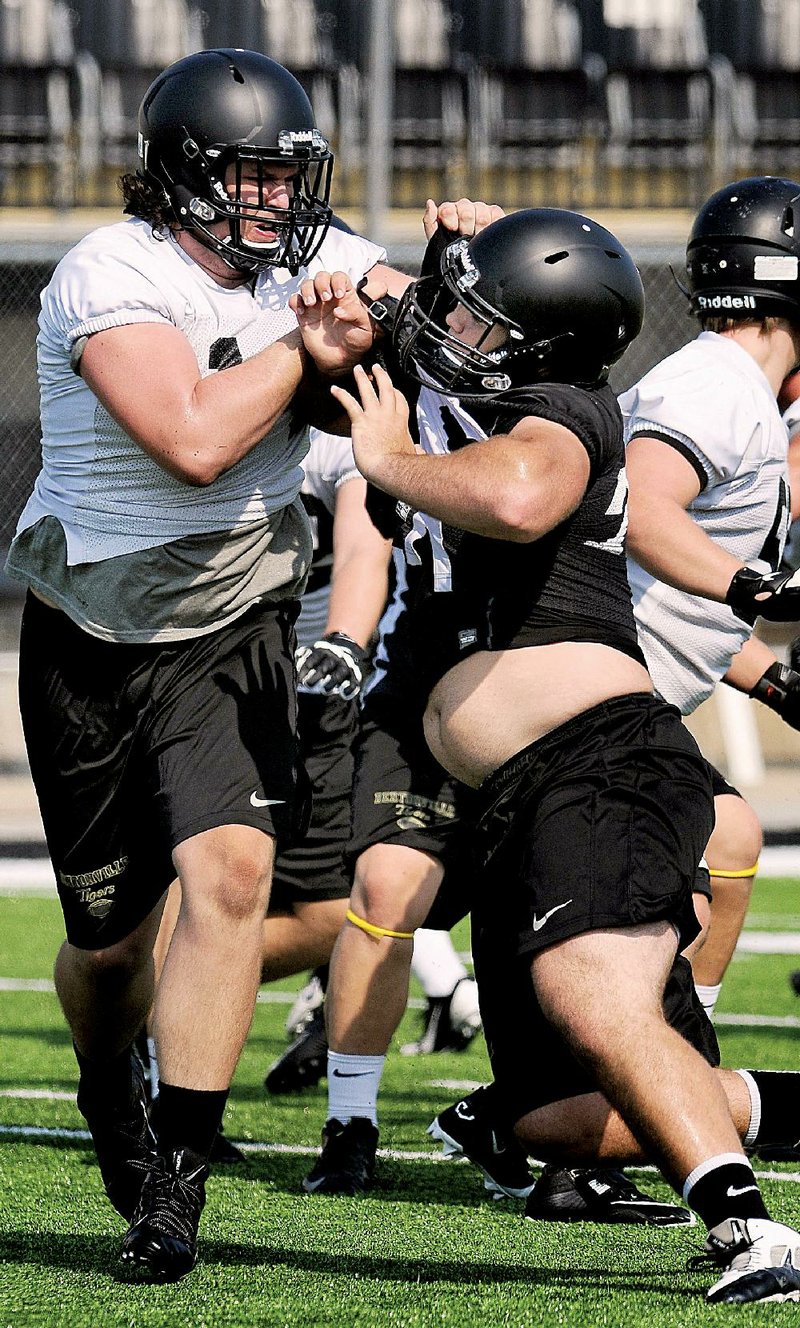 Ean Pfeifer (left), a 6-5, 295-pound guard, will anchor Bentonville’s offensive line this season and has received scholarship offers from 11 Division I schools, including Arkansas State.