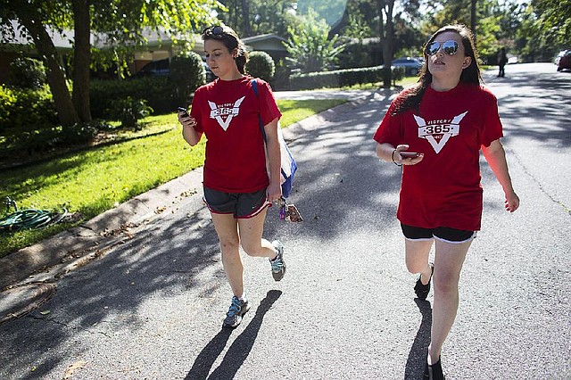 Arkansas Democrat-Gazette/MELISSA SUE GERRITS - 08/23/2014 - LeFlore Barbour, left, and Aly Humphrey, volunteers with the Victory Campaign, use a canvasing and navigational app that streamlines their approach to canvasing neighborhoods near Maumelle, AR August 23, 2014. 