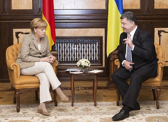 German chancellor Angela Merkel, left, and Ukrainian President Petro Poroshenko during their meeting in Kiev, Ukraine, Saturday, Aug. 23, 2014. Merkel, who has advocated a measured European Union response to Russia’s aggressive policies in Ukraine, met Saturday in Kiev to meet Ukrainian President Petro Poroshenko and said she urged a political solution to the crisis. Poroshenko, for his part, said Ukraine was willing to try to solve the conflict by talks, but not at the expense of the country’s territorial integrity or sovereignty. (AP Photo/Mykhailo Markiv, Pool)