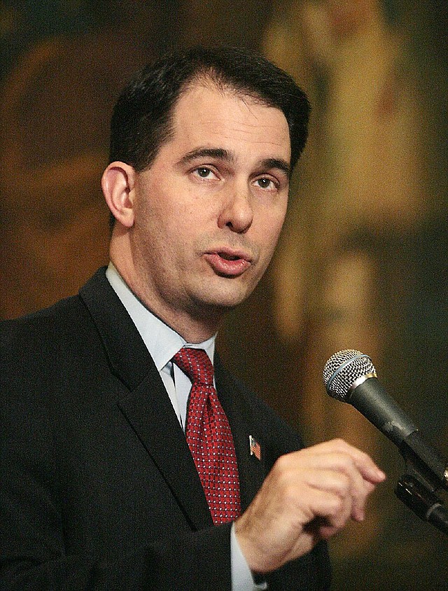 Wisconsin Governor Scott Walker responds to questions from the media during a ceremonial signing of his budget repair bill at the State Capitol building in Madison, Wis.  Wednesday, April 6, 2011. The bill is an amended version of Walker's original legislation, which repealed most collective bargaining options of public employees. That portion of the bill is facing legal challenges and is presently stalled in the state's court system. (AP Photo/Wisconsin State Journal, John Hart)