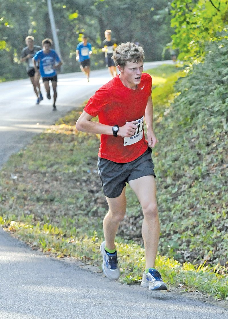  STAFF PHOTO FLIP PUTTHOFF Christian Liddell nears the top of &#8220;Eliminator Hill&#8221; on his way to winning the Frisco Festival Eliminator 5K race on Saturday.