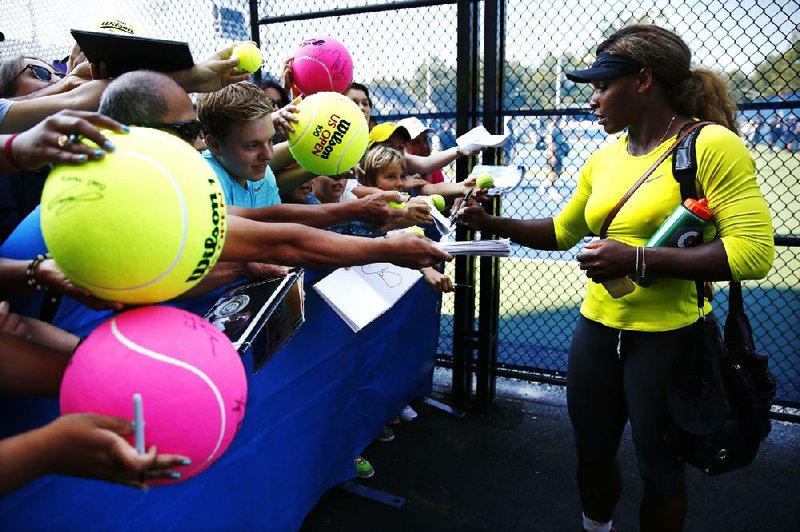 Serena Williams signs autographs after practicing ahead of the of the 2014 U.S. Open tennis tournament, Sunday, Aug. 24, 2014, in New York. (AP Photo/Matt Rourke)