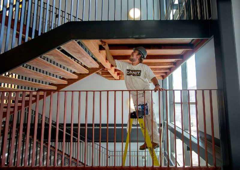 NWA Media/JASON IVESTER --08/21/2014--
John Carter with MVP Painting in Kansas City paints in a stairwell on Thursday, Aug. 21, 2014, inside the new Joplin High School in Joplin, Mo. The school was originally scheduled to open with the rest of the school district on Monday, Aug. 25, but was pushed back to Tuesday, Sept. 2.