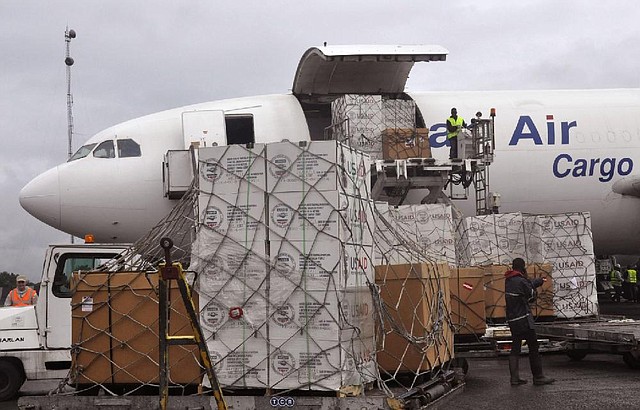 American Aid goods are offloaded from an airplane, to be used in the fight against the Ebola virus spreading in the city of  Monrovia, Liberia, Sunday, Aug. 24, 2014. Two alarming new cases of Ebola have emerged in Nigeria, widening the circle of people sickened beyond the immediate group of caregivers who treated a dying airline passenger in one of Africa's largest cities. The outbreak also continues to spread elsewhere in West Africa, with 142 more cases recorded, bringing the new total to 2,615 with 1,427 deaths, the World Health Organization said Friday. (AP Photo/Abbas Dulleh)