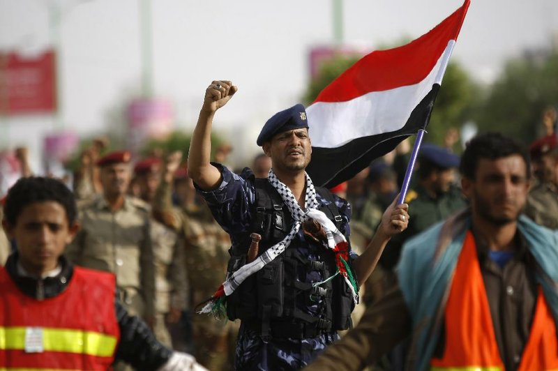 A Yemeni officer who is a member of Shiite Hawthi rebels chants slogans demanding the government step down during a demonstration on a street in Sanaa, Yemen, Sunday, Aug. 24, 2014. Yemen's Shiite rebel group called for new protests Sunday after rejecting a draft proposal by a presidential delegation to stop their demonstrations in return for a new government and a review of the country's economic policies. (AP Photo/Hani Mohammed)