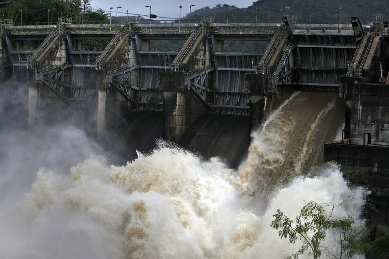 Water rushes through an open bay at the Carraizo Dam to release water left by a passing storm in Trujillo Alto, Puerto Rico, Saturday, Aug. 23, 2014. A tropical depression formed over the Turks and Caicos Islands on Saturday as it headed toward the Bahamas and dumped heavy rains on parts of Puerto Rico and the Dominican Republic, according to the U.S. Hurricane Center. (AP Photo/Ricardo Arduengo)