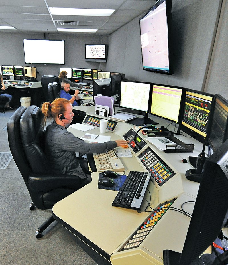 STAFF PHOTO J.T. Wampler Heather Bowlin, a dispatcher at Springdale Police Department&#8217;s dispatch center, works Friday.