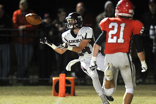 Lincoln receiver Alec Pitts pulls in a touchdown pass past Farmington defender Cody Larrow in the first half of a Friday, Nov. 8, 2013 game at Allan Holland Field in Farmington.