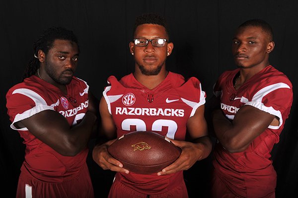 Arkansas running backs (from left to right) Alex Collins, Jonathan Williams and Korliss Marshall pose during the Razorbacks' media day on Sunday, Aug. 10, 2014 in Fayetteville. 